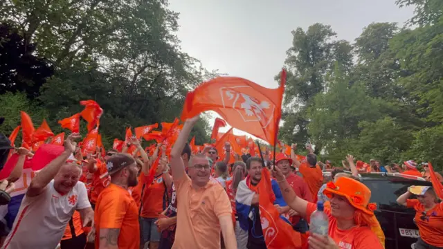Netherlands fans dance in the rain