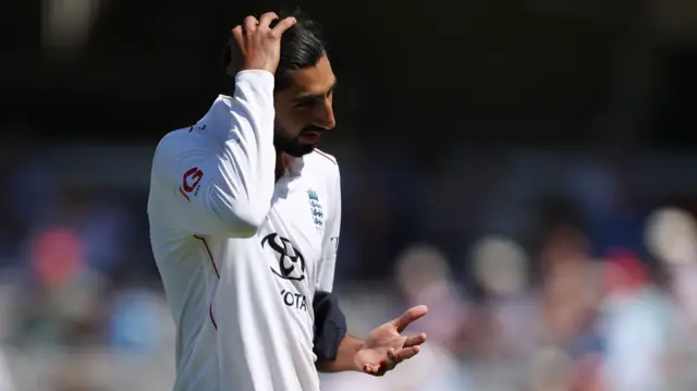 Shoaib Bashir walks off the field with a finger injury