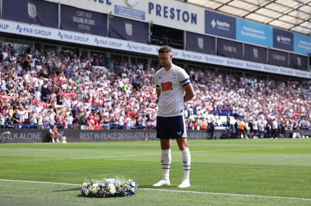 Ben Whiteman with a wreath in tribute to Diogo Jota