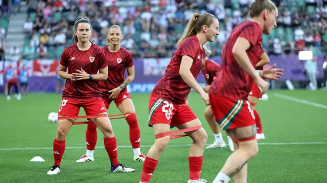 Esther Morgan of Wales warms up with teammates