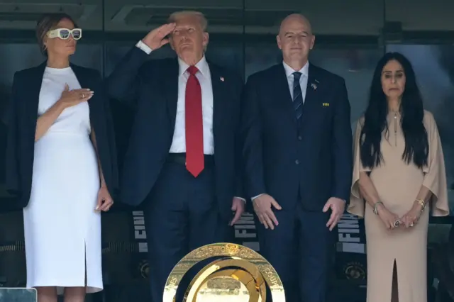 Donald Trump salutes during the American national anthem.
