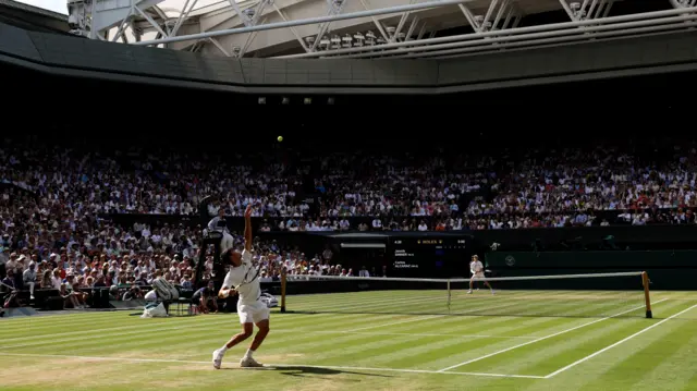 Carlos Alcaraz serves