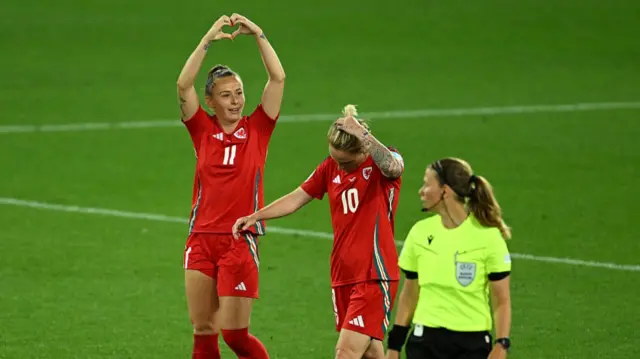 Hannah Cain of Wales celebrates scoring her team's first goal