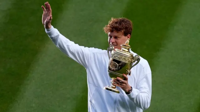 Jannik Sinner holds the Wimbledon trophy