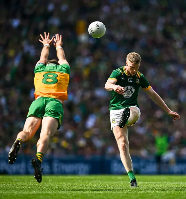 Mathew Costello of Meath shoots under pressure from Eoghan Bán Gallagher of Donegal