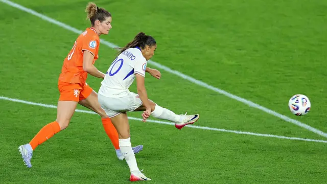 Delphine Cascarino of France scores her team's third goal under pressure from Dominique Janssen of the Netherlands