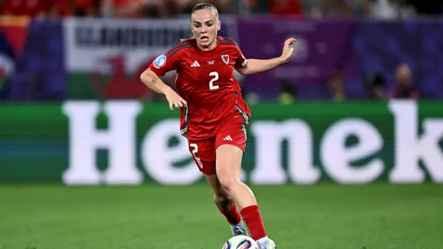 Wales' defender #02 Lily Woodham runs with the ball