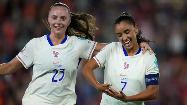 Sakina Karchaoui of France celebrates scoring her team's fifth goal from the penalty spot with teammate Lou Bogaert during the UEFA Women's EURO 2025 Group D match between Netherlands and France at St. Jakob-Park