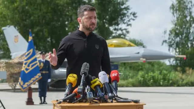 President of Ukraine Volodymyr Zelenskyi stands in front of the first General Dynamics F-16 Fighting Falcon received by Ukraine