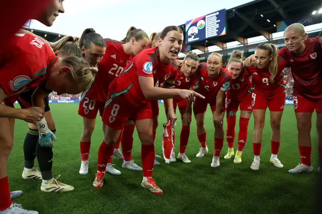 Angharad James-Turner of Wales leads a team talk