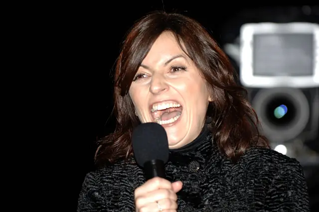 Big Brother host Davina McCall laughs outside the Big Brother house while presenting