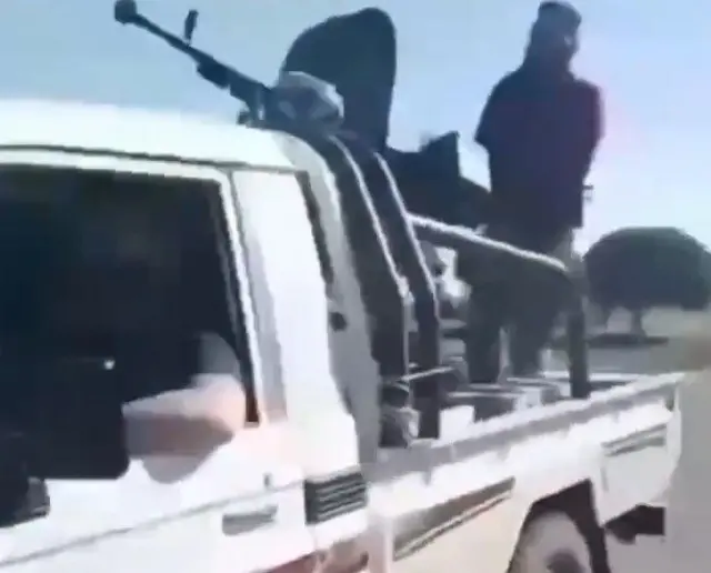 Screengrab showing gunmen on the streets in southern Syria following sectarian clashes.