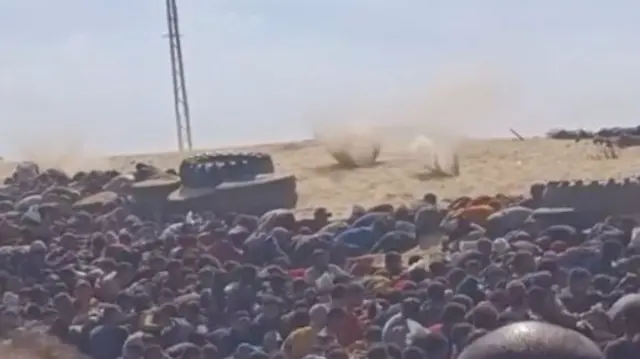 A screengrab taken from the verified video shows sand being kicked up by the bullets