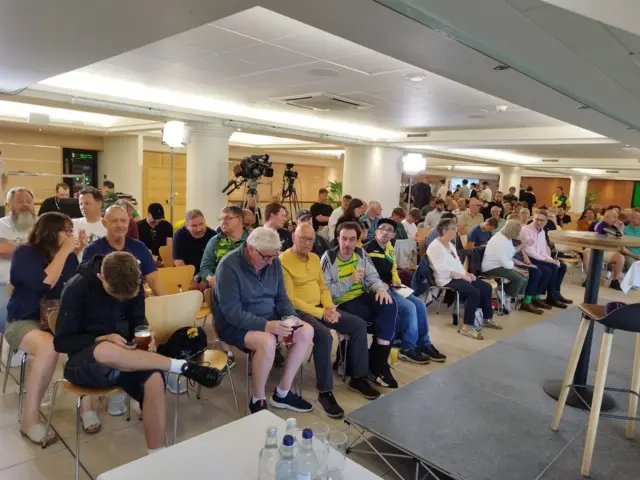 Football supporters sitting in seats waiting for the start of a question and answer event