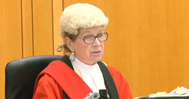 Mrs Justice Lambert in wig and glasses in court