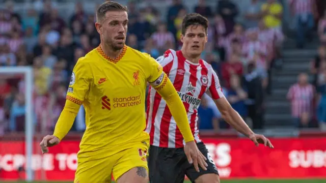 Liverpool's Jordan Henderson under pressure from Brentford's Christian Norgaard