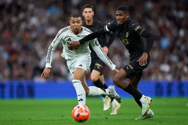 Kylian Mbappe of Real Madrid CF battle for the ball with Cristhian Mosquera of Valencia