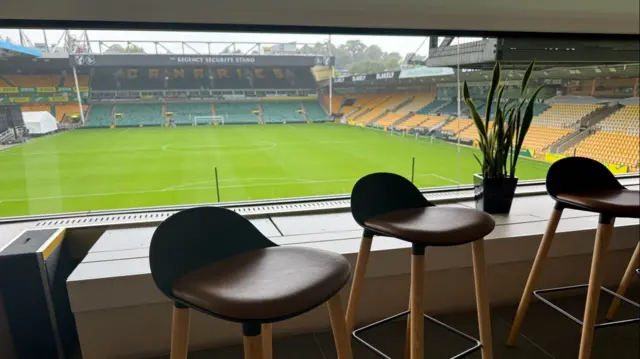 A view of a football stadium pitch from an executive box.