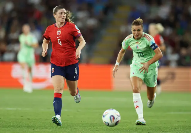 Maren Mjelde of Norway and Cristiana Girelli of Italy run towards a loose ball during the UEFA Women's EURO 2025 Quarter-Final match between Norway and Italy at Stade de Geneve on July 16, 2025 in Geneva, Switzerland. (