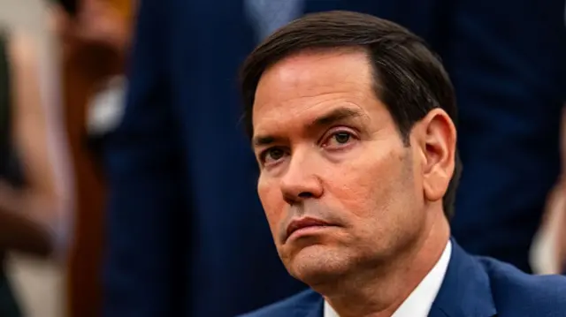 Headshot of Marco Rubio, who looks stern as he looks above the camera