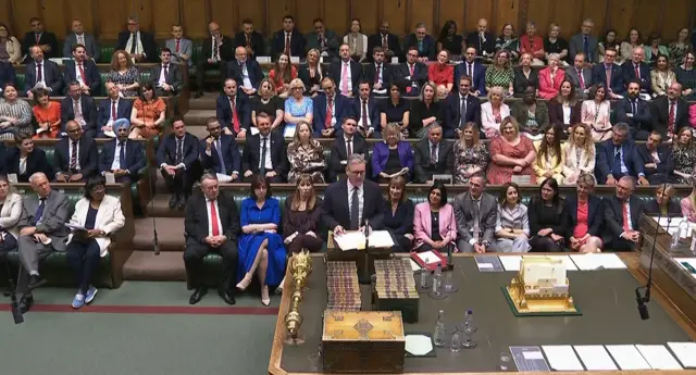 Starmer stands at the despatch box with packed rows of MPs behind him in the House of Commons
