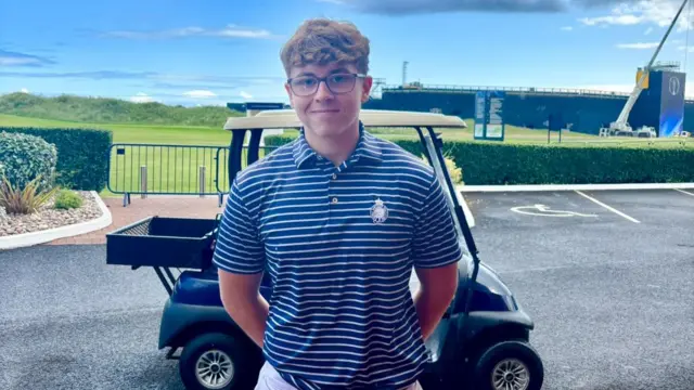 Noah Beggs stands in front of a golf buggy at Royal Portrush