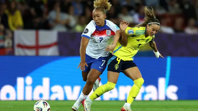 Lauren James of England runs with the ball whilst being challenged by Kosovare Asllani of Sweden