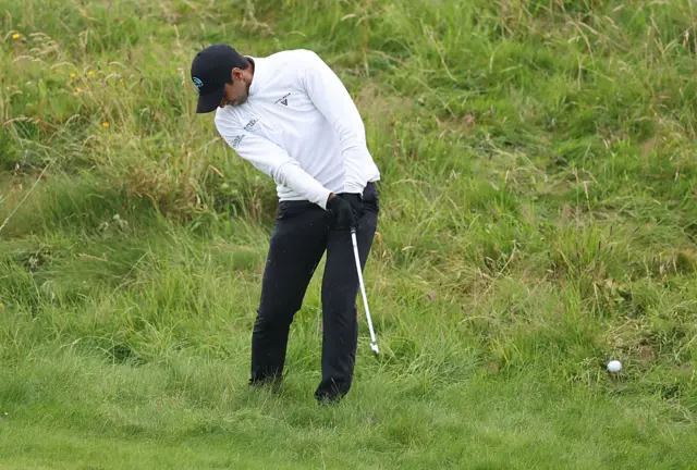 Aaron Rai hits the ball out of the rough