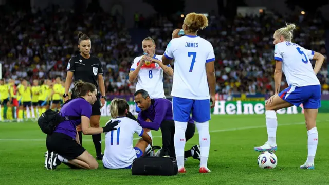 Lauren Hemp of England receives medical treatment,