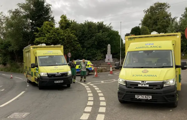 Two ambulances are seen parked up on a rural road in Wheddon Cross in Somerset
