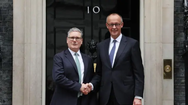 British Prime Minister Keir Starmer (L) shakes hands with German Chancellor Friedrich Merz upon their arrival at Downing Street, in London, Britain, 17 July 2025.