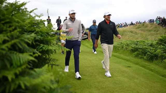 Sam Burns and Brooks Koepka walk along Royal Portrush during the 153rd Open Championship