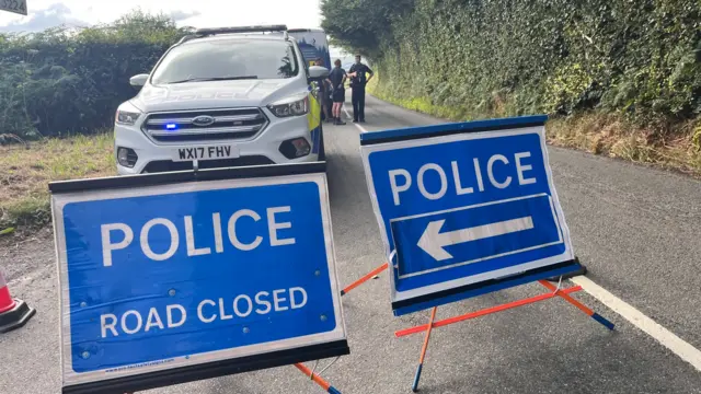 Police road closed sign