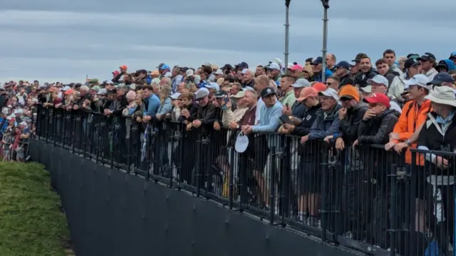 Fans lining the sixth hole