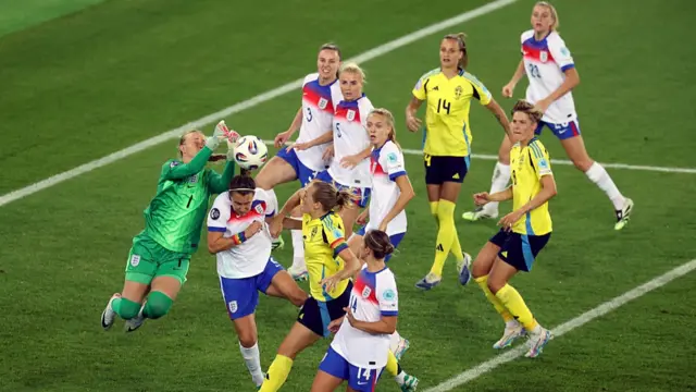 Hannah Hampton of England attempts to punch a crossed ball over the head of team mate Lucy Bronze