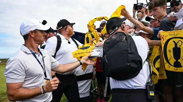 Rory McIlroy signs autographs