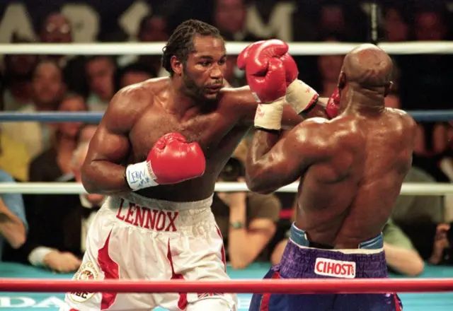 Lennox Lewis landing a punch on Evander Holyfield in November 1999