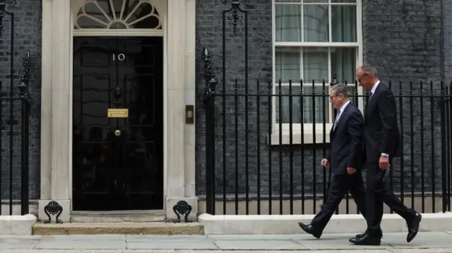 Starmer and Merz walk side by side towards the door to No 10