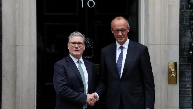 Starmer and Merz shake hands outside the door to No 10