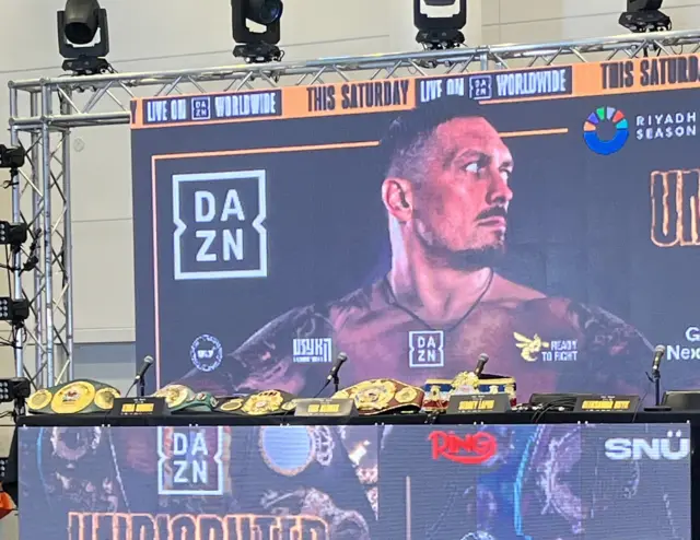 Oleksandr Usyk's heavyweight world title belts on a table