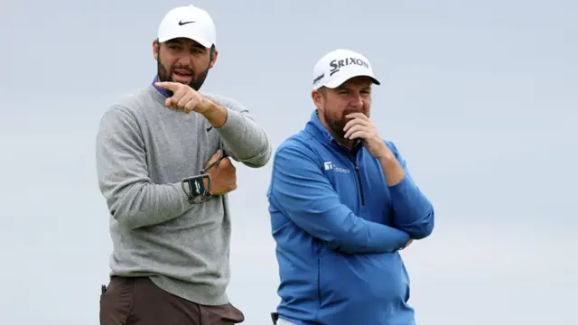Scottie Scheffler and Shane Lowry watch on during the Open at Royal Portrush