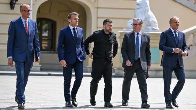 From left to right: Friedrich Merz, Emmanuel Macron, Volodymyr Zelensky, Keir Starmer and Donald Tusk walk together in Kyiv