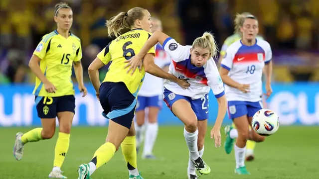 Alessia Russo of England chases the ball whilst being held by Magdalena Eriksson of Sweden