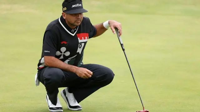 Jason Day squats before a putt at The Open
