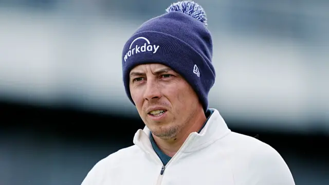 Matt Fitzpatrick watches on wearing a beanie hat during The Open Championship 2025
