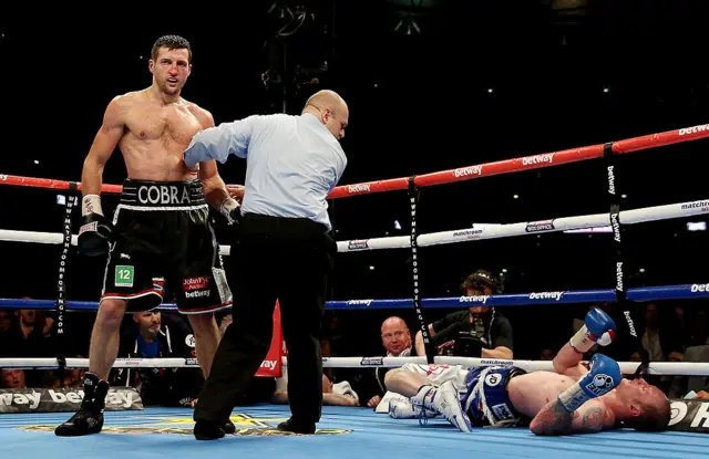 Carl Froch standing over George Groves
