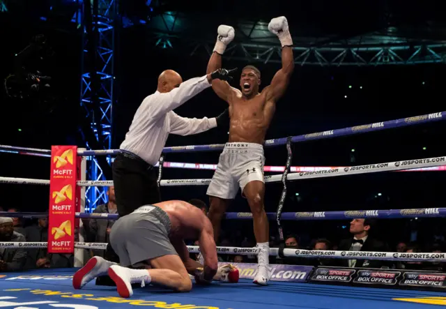 Anthony Joshua with his hands in the air