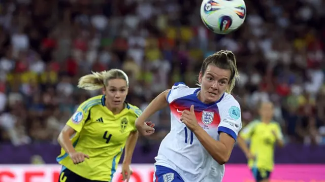 Lauren Hemp of England chases an aerial ball whilst under pressure from Hanna Lundkvist of Sweden