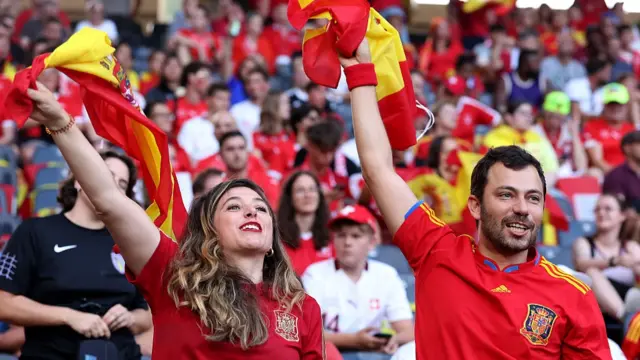 Fans of Spain wave their national flags as they enjoy the pre-match atmosphere