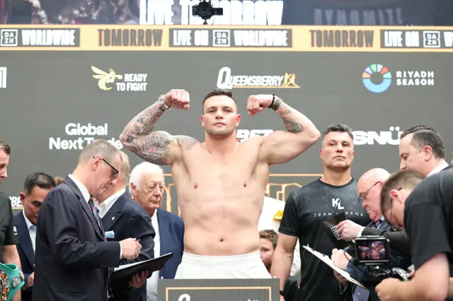 Kevin Lerena flexes as he weighs in